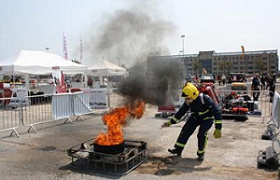 A firefighter putting out a fire Description automatically generated