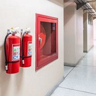 A fire extinguisher on the wall Description automatically generated