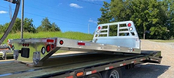 A flatbed trailer with a flat bed Description automatically generated