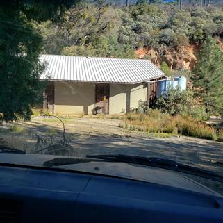 A house with a metal roof

Description automatically generated